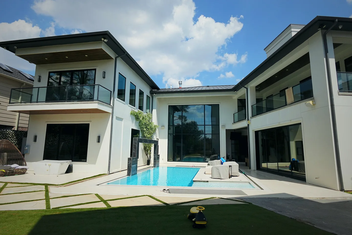 A modern two-storey Houston home with full-height glass and a courtyard pool, cleaned inside and out